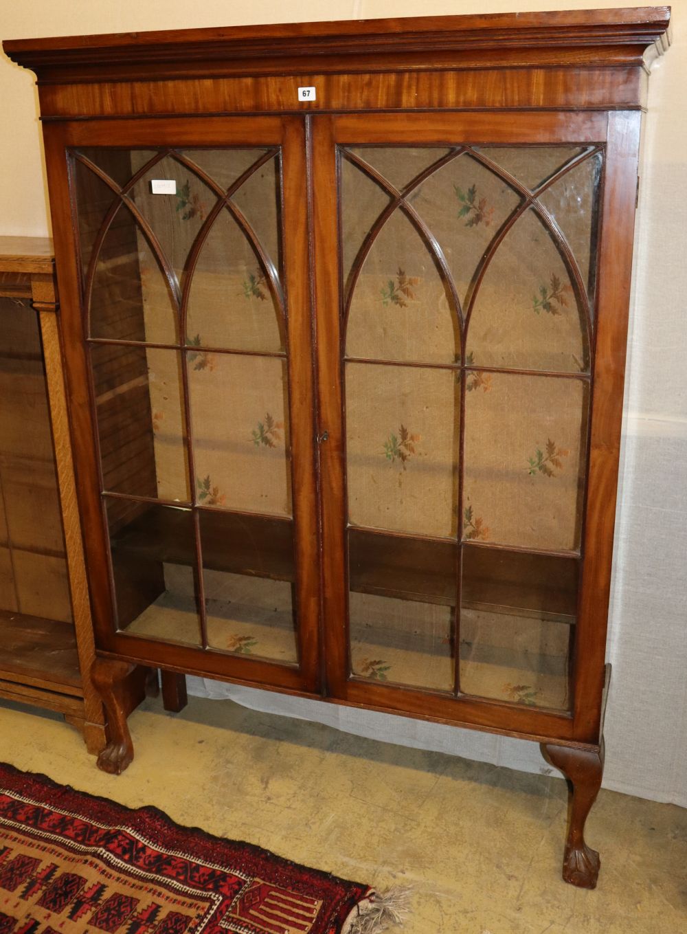 A mahogany bookcase on cabriole legs, W.119cm, D.33cm, H.163cm